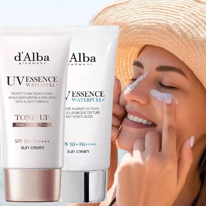 A smiling woman applies sunscreen to her nose. In the foreground, two tubes of 2PCS 50ml Full Body UV Protection Sunscreen, offering hydrating, refreshing, breathable sun protection, are displayed. One tube is labeled Tone-Up Pink Correcting.